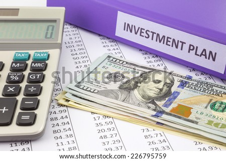 Money place on financial report with purple binder of investment plan,  concept for saving fund and return on investment