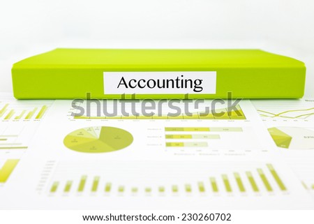 Green document binder with Accounting word place on graphs analysis and financial reports