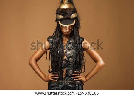 beautiful dark-skinned woman dressed in a military uniform Spartan.