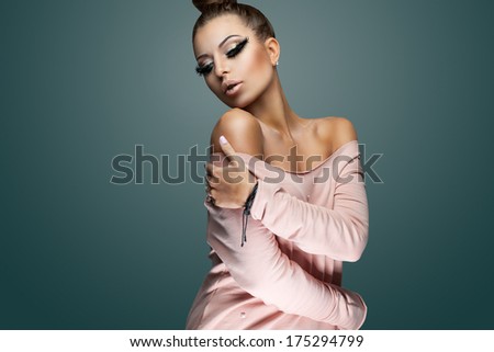 young woman hugging herself with her eyes closed