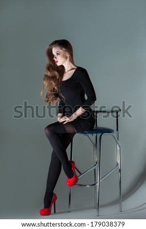 beautiful girl sitting on a bar stool