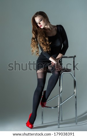 beautiful girl sitting on a bar stool