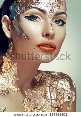 woman decorated with gold leaf