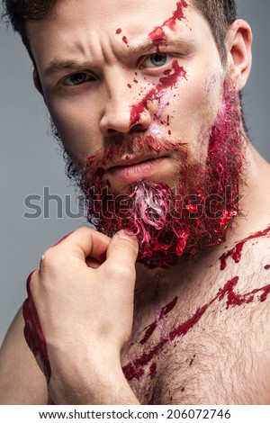 portrait of a bearded man smeared in paint