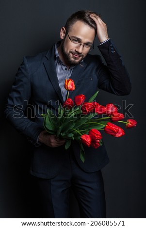 portrait of a handsome man with a bouquet of flowers