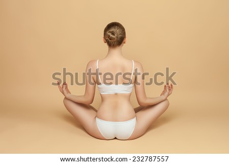 beautiful woman in underwear sitting on the floor, perfect figure