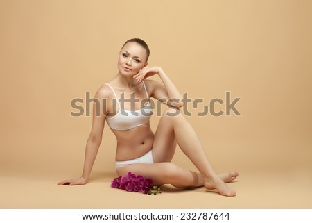 beautiful woman in underwear sitting on the floor, perfect figure