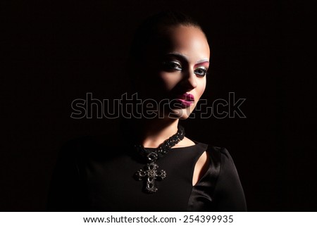 Fishing beautiful woman with aggressive make-up in the dark