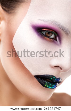 girl on white background and a beautiful mask on her face