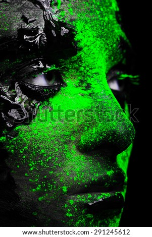close-up of a woman\'s face covered with paint
