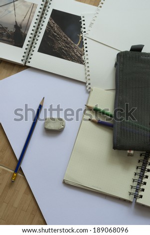 Blank paper,pencils,and sketch book on the wooden floor