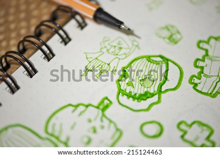 sketch of cartoon skull in notebook , selective focus.
