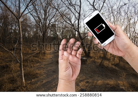 A man has a low battery problem with Smartphone while find the way out of Forest.