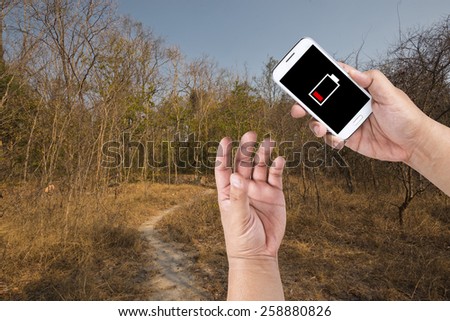 A man has a low battery problem with Smartphone while find the way out of Forest.
