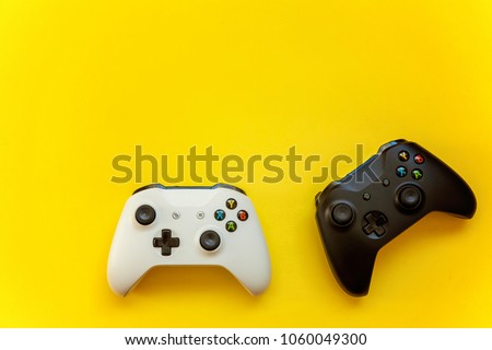 Black and white joystick on yellow background. Computer gaming competition videogame control confrontation concept