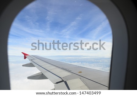 looking the sky through airplane window with window frame