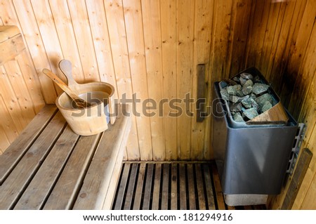 sauna corner with heater and wooden bucket