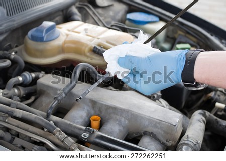 Mechanic checks the oil level in the engine