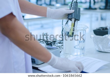 scientist used chemical solution and lab testing for water quality or ph meter in laboratory ,research and science concept