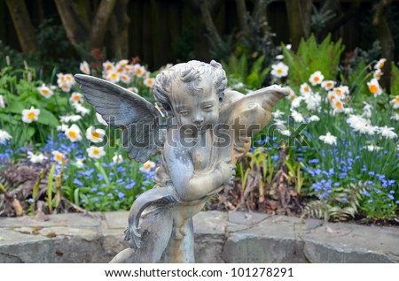Little angel statue in spring garden