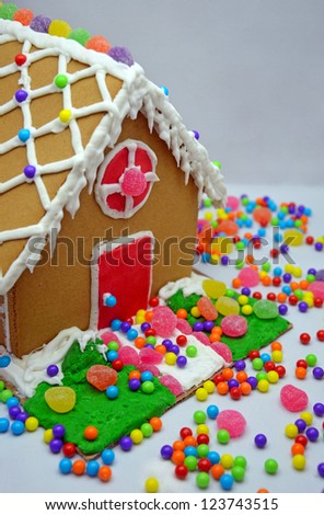 Little decorated gingerbread house and colorful candy