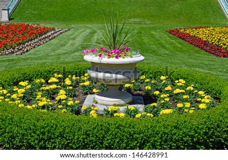 Colorful garden park planter with petunias and marigolds