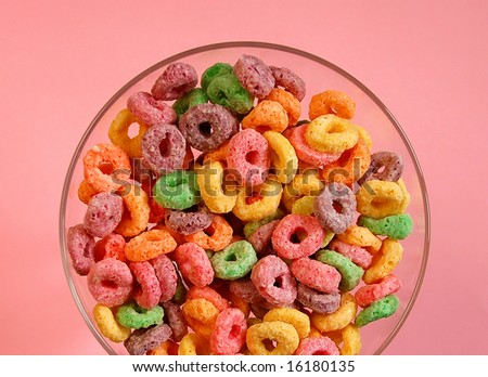 Bowl of colorful cereal on pink background