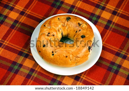 Blueberry bagel on white plate