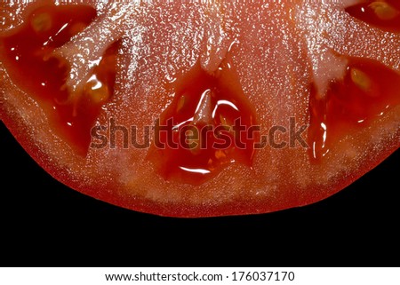 Fresh red tomatoe slice on black background