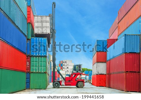 forklift handling container box loading to truck in container depot