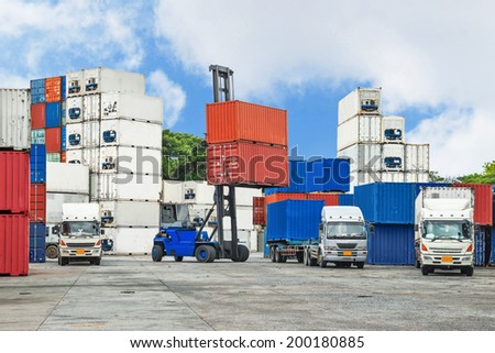 Crane lifter handling container box loading to truck in import export logistic zone Crane lifter handling container box loading to truck in import export logistic zone