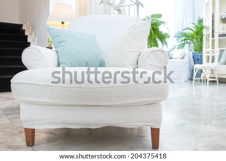 white armchair with pillow in living room ,vintage style