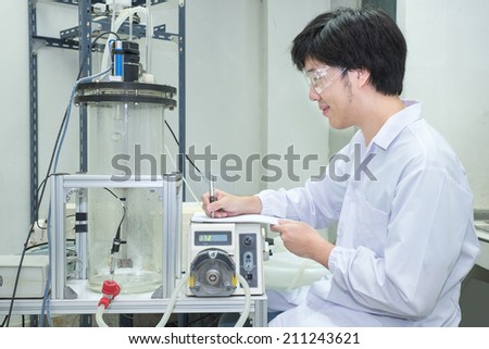 Scientist conducting research taking notes  in laboratory