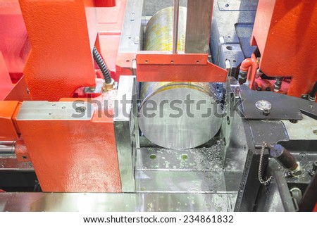 Close up steel band saw machine working in factory. Selective focus at saw