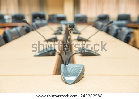 Before a conference, the microphones in front of empty chairs. Selective focus