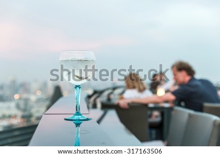 Gin tonic cocktail on table in rooftop bar