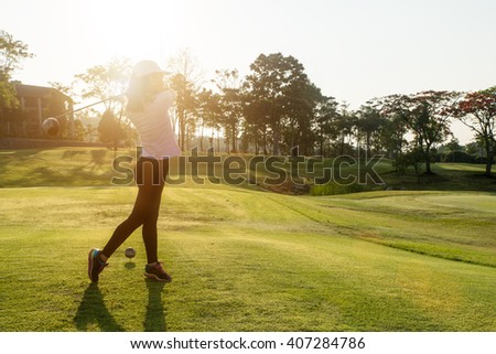 Sport, Golf , People concept - Asian woman golfer hit sweeping golf course in the summer. Asian woman looking enjoy to play golf sport.