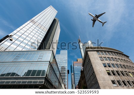 Frankfurt skyscrapers buildings and a plane flying overhead in morning at Frankfurt, Germany.