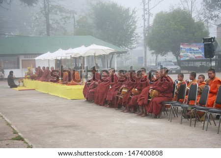 LOEI,THAILAND - JANUARY 1 : Tak Bat Ceremony on the Occasion of the New Year Celebrations.Many People Give Food to Buddhist Monks for alms on January 1,2011 in Loei,Thailand.