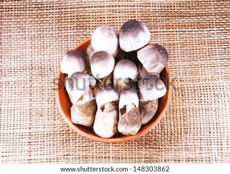 Straw mushroom in clay bowl on  Straw mat