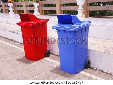red and blue recycle bins in the park