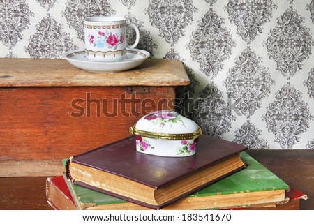 still life with old book,tea cup on wooden table.