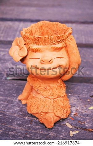 little girl baked clay dolls for decorate garden and house