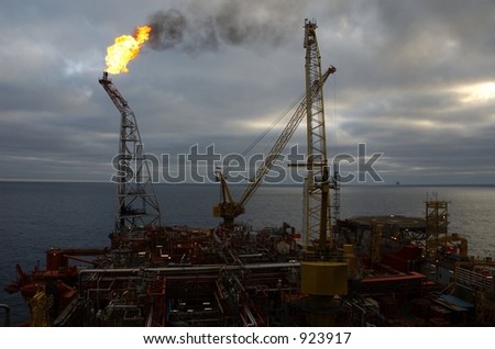 Top deck, flare tower and crane on offshore oil rig