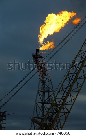 Flare tower on offshore oil rig in early morning (some noise)