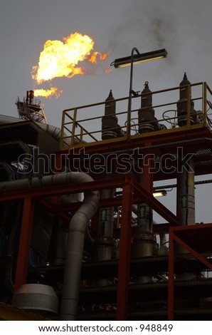 Abstract of flare tower behind production facilities on offshore oil rig