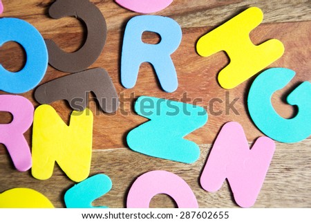 colorful letters on wooden background