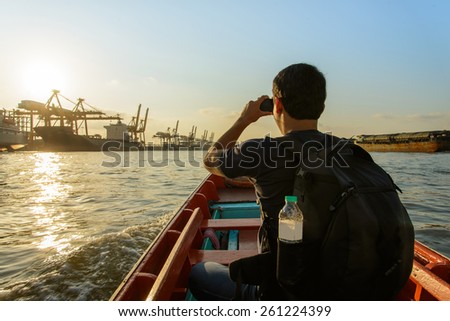 Photographer take a photo Industrial Port in the morning with smart phone