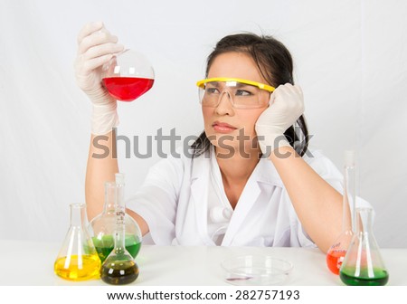 Scientist serious clinician studying chemical element in laboratory