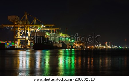 Industrial Port in night time with Oil refinery background